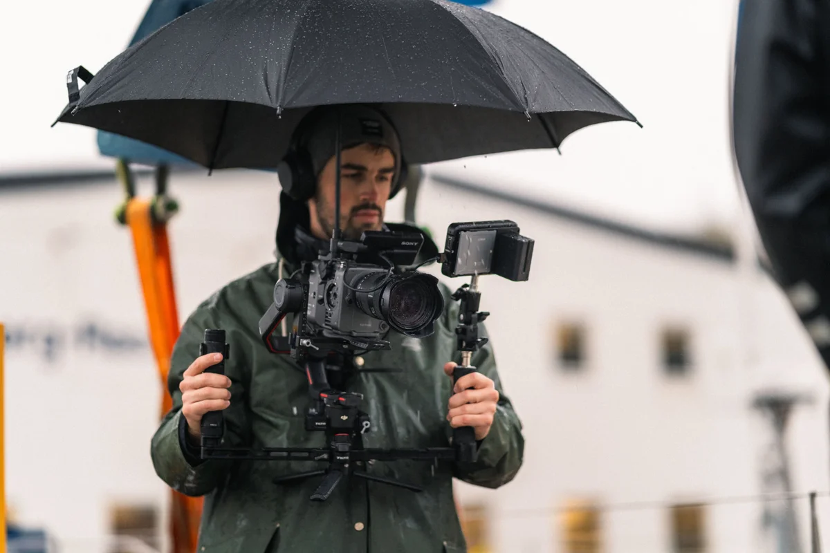 Anton Bylund filming on location in the rain